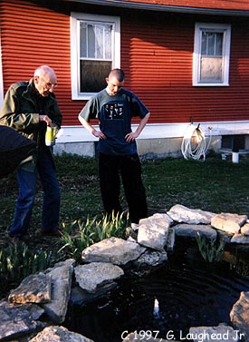 Beat Generation writer William S. Burroughs and Dan Diaz feeding fish outside
William's bedroom window, March 26, 1997. Copyright, George Laughead Jr.,
1997.